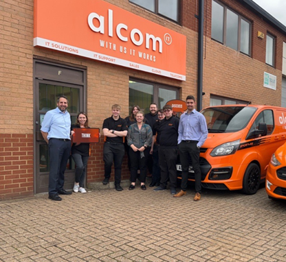 The Alcom IT team with their branded service vans